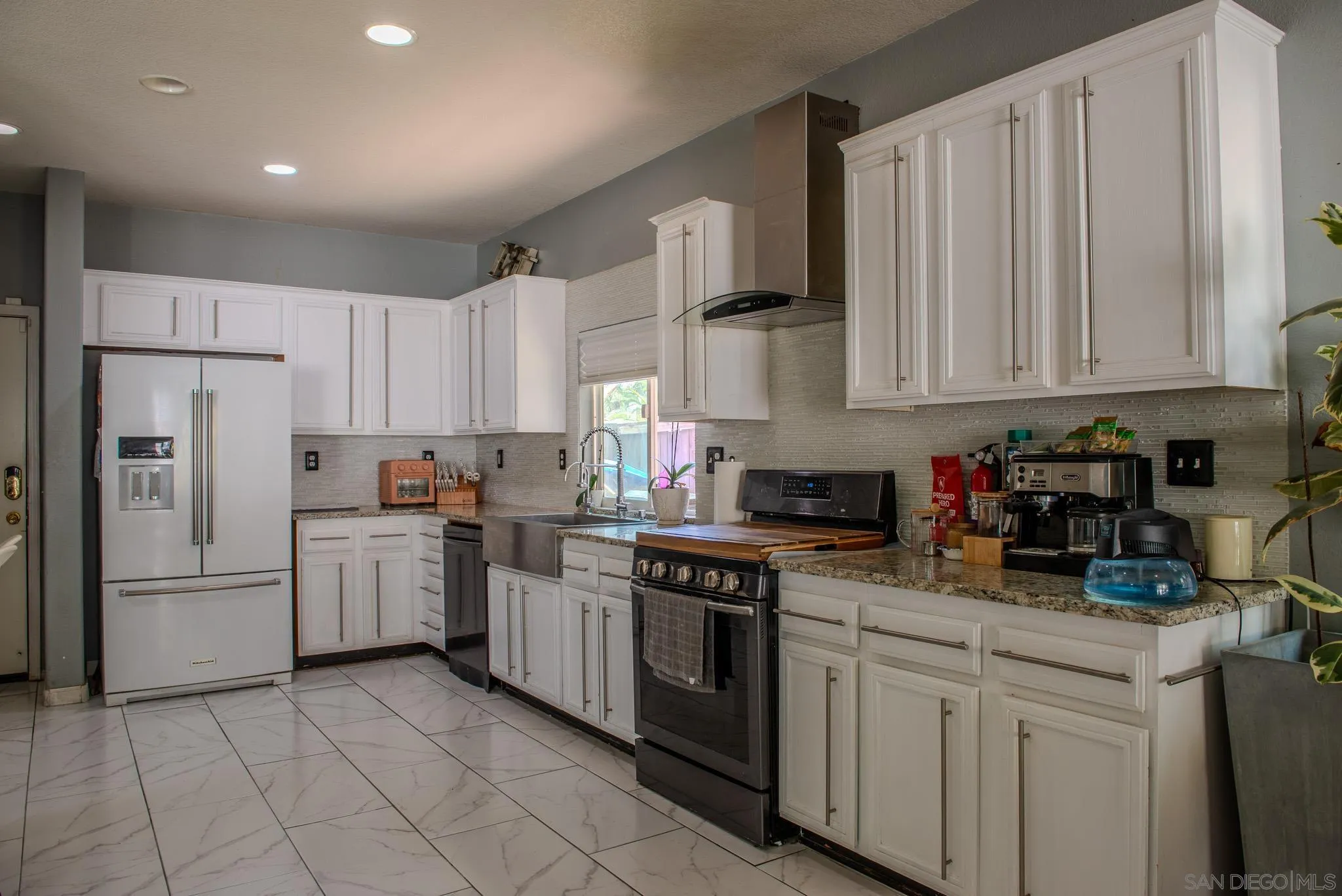 33567 Magnetite Street Menifee, CA 92584 - Photo 19 of 49 a kitchen with stainless steel appliances granite countertop a refrigerator sink and cabinets