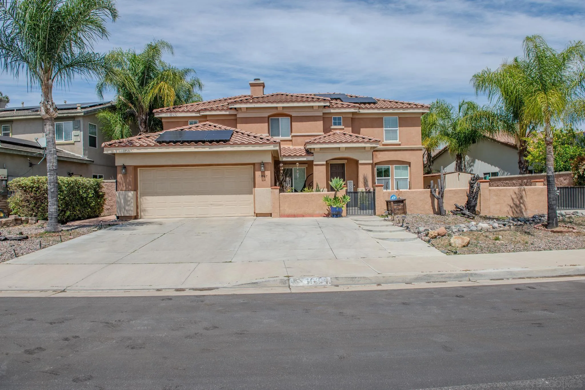 33567 Magnetite Street Menifee, CA 92584 - Photo 2 of 49 front view of a house with a yard and palm trees