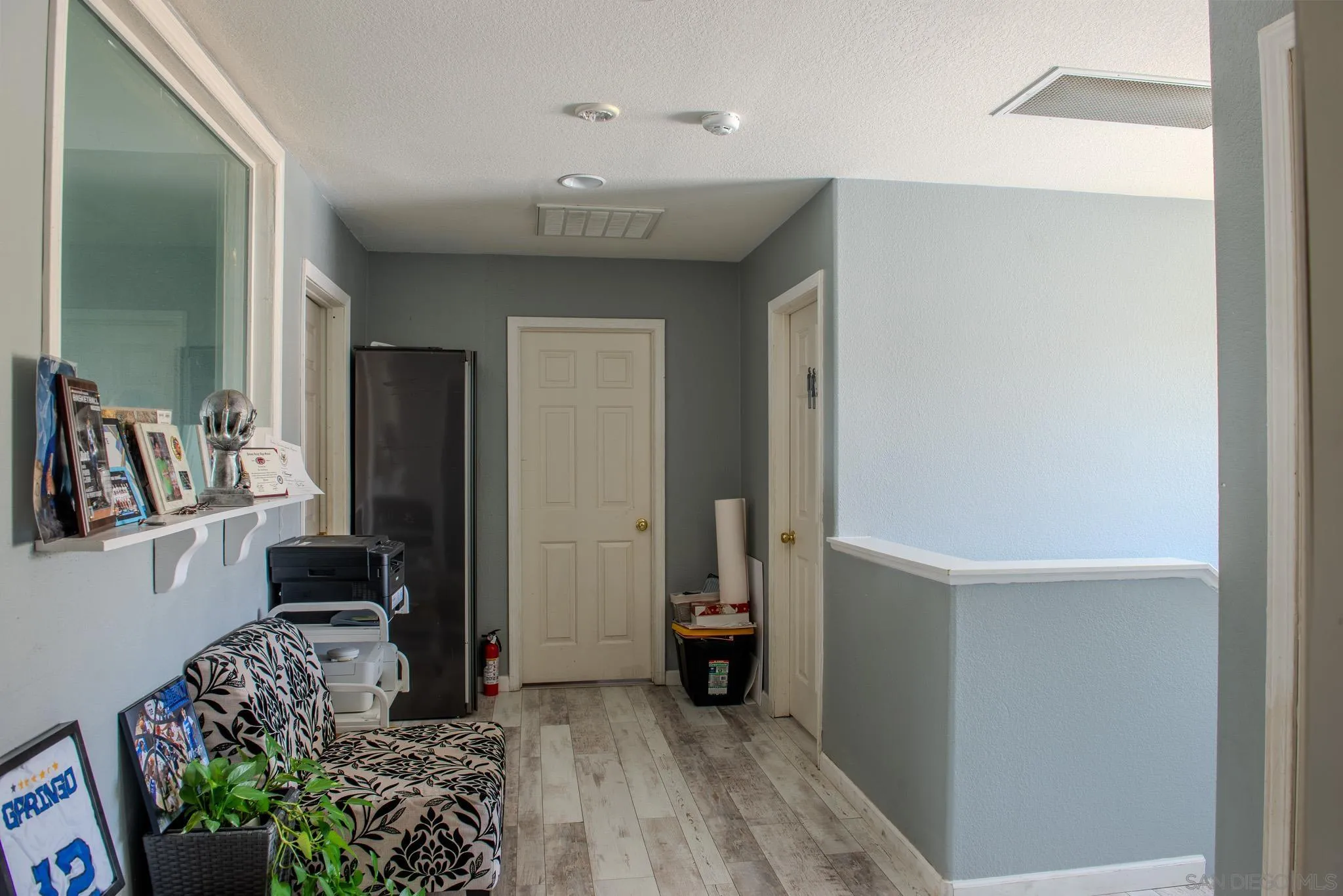 33567 Magnetite Street Menifee, CA 92584 - Photo 24 of 49 a view of a hallway and a livingroom with furniture