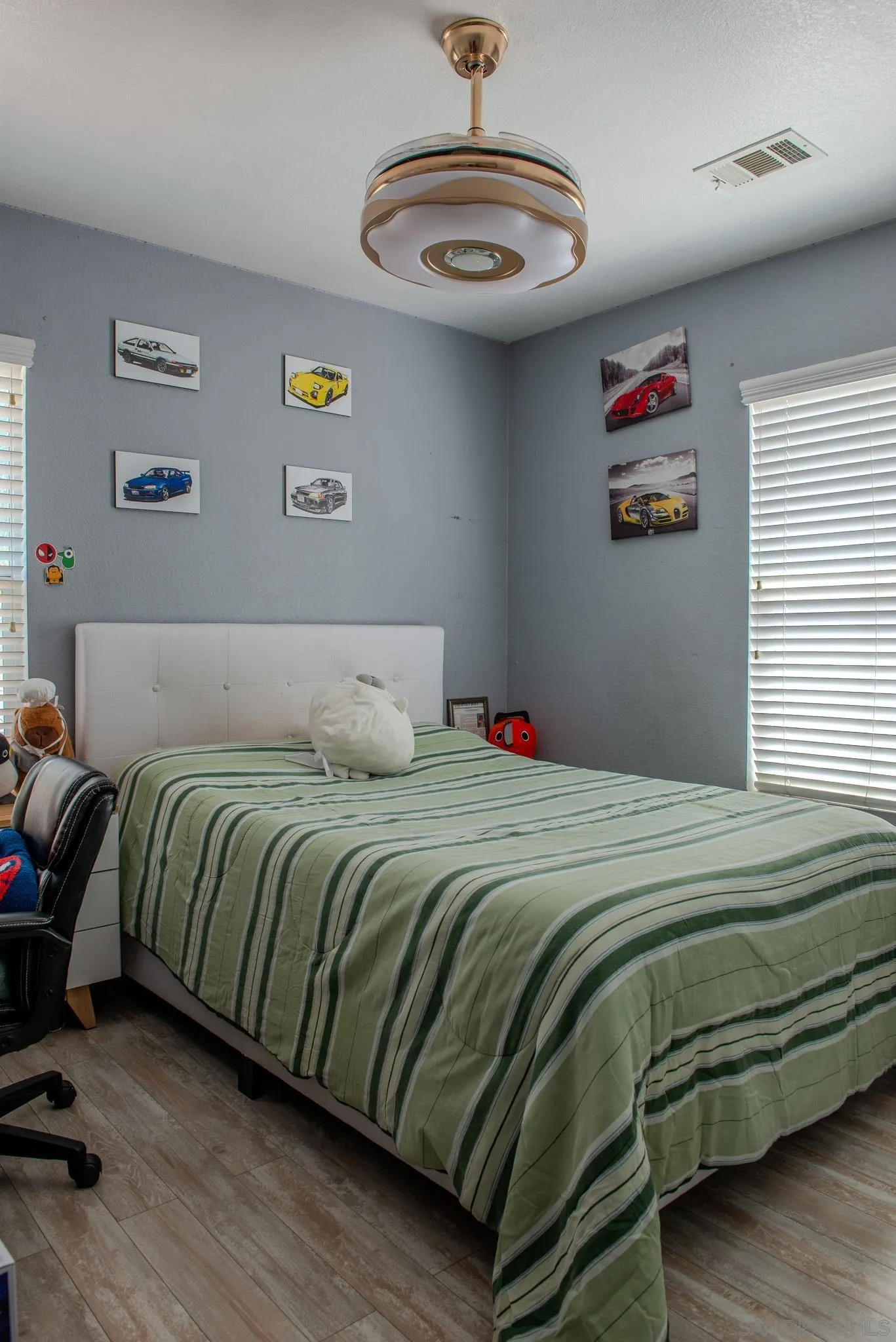 33567 Magnetite Street Menifee, CA 92584 - Photo 29 of 49 a bedroom with a bed and a chandelier
