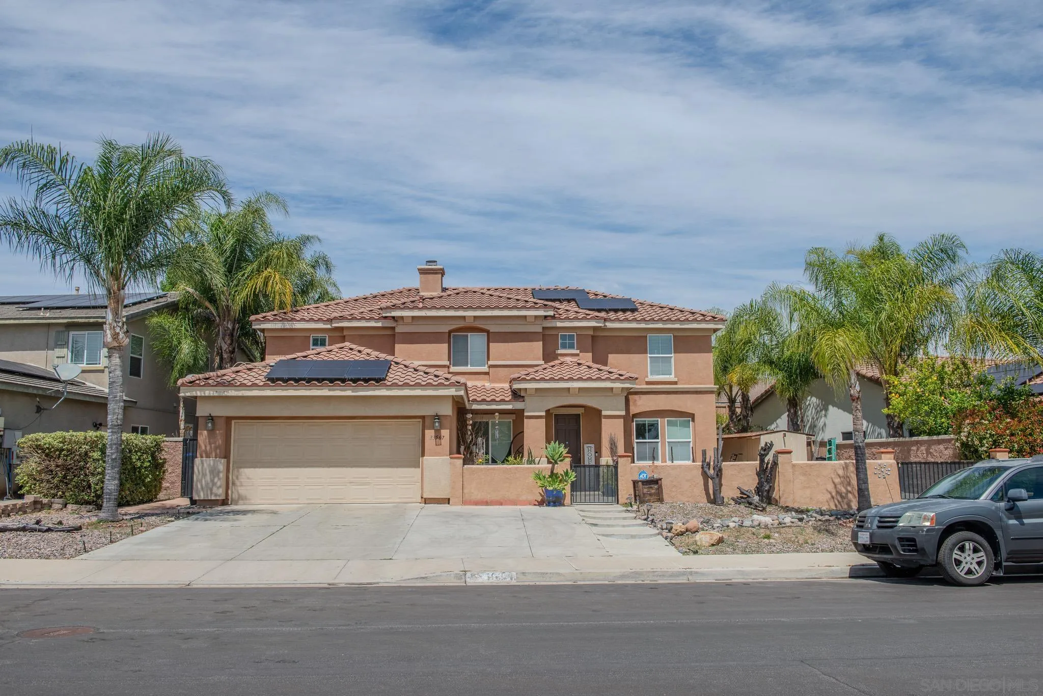 33567 Magnetite Street Menifee, CA 92584 - Photo 3 of 49 a front view of a house with a garden and parking
