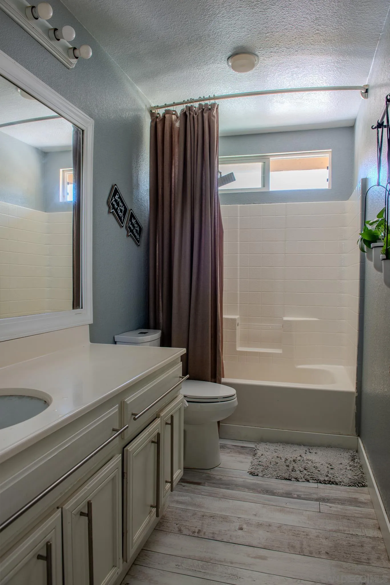 33567 Magnetite Street Menifee, CA 92584 - Photo 32 of 49 a bathroom with a sink and a mirror