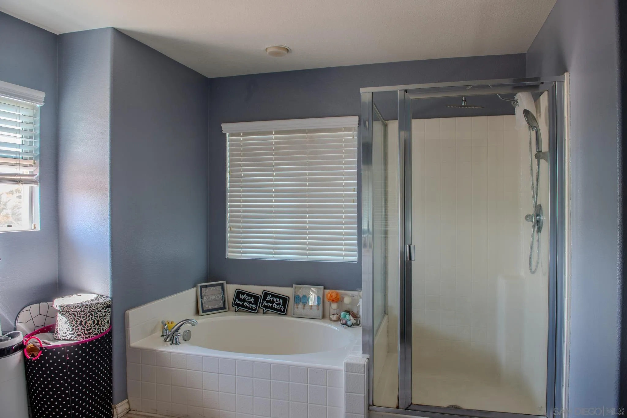 33567 Magnetite Street Menifee, CA 92584 - Photo 36 of 49 a bathroom with a bathtub and a shower