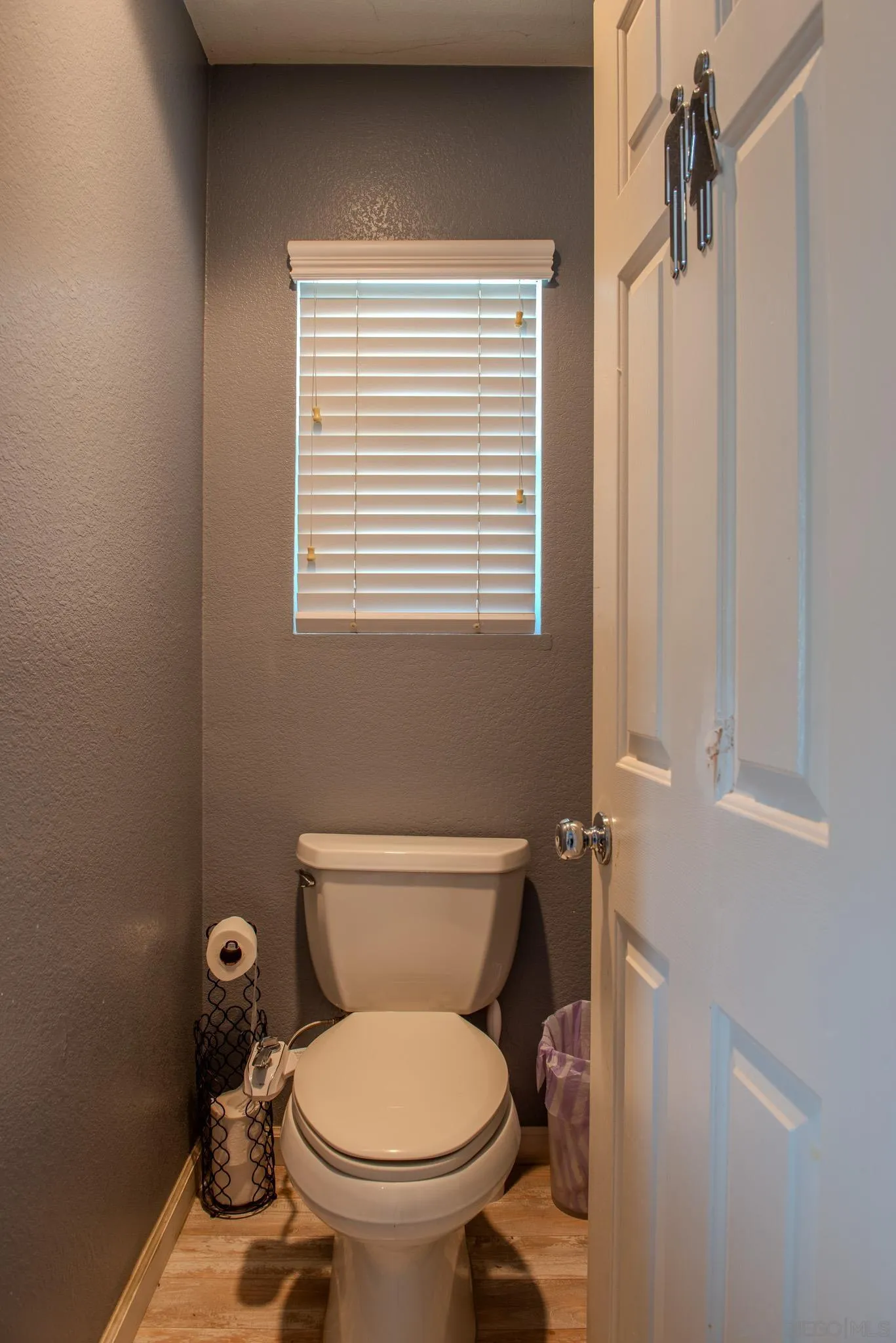 33567 Magnetite Street Menifee, CA 92584 - Photo 41 of 49 a white toilet sitting next to a window