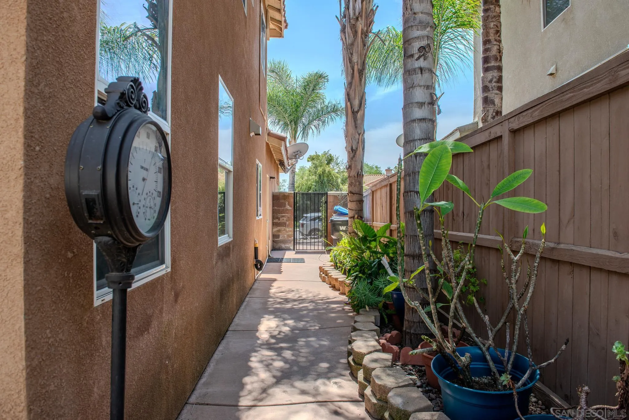 33567 Magnetite Street Menifee, CA 92584 - Photo 48 of 49 a backyard with potted plants and a large tree