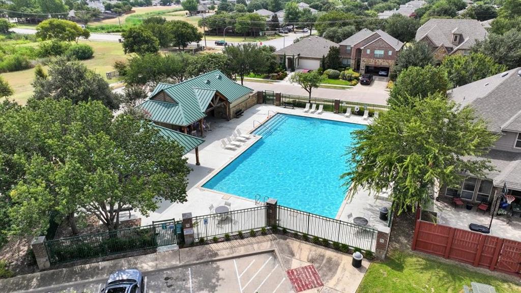 1201 Timberhurst Trail Fort Worth, TX 76131 - Photo 38 of 40 Community swimming pool with surrounding concrete decking, a covered pavilion with a green metal roof, and perimeter fencing
