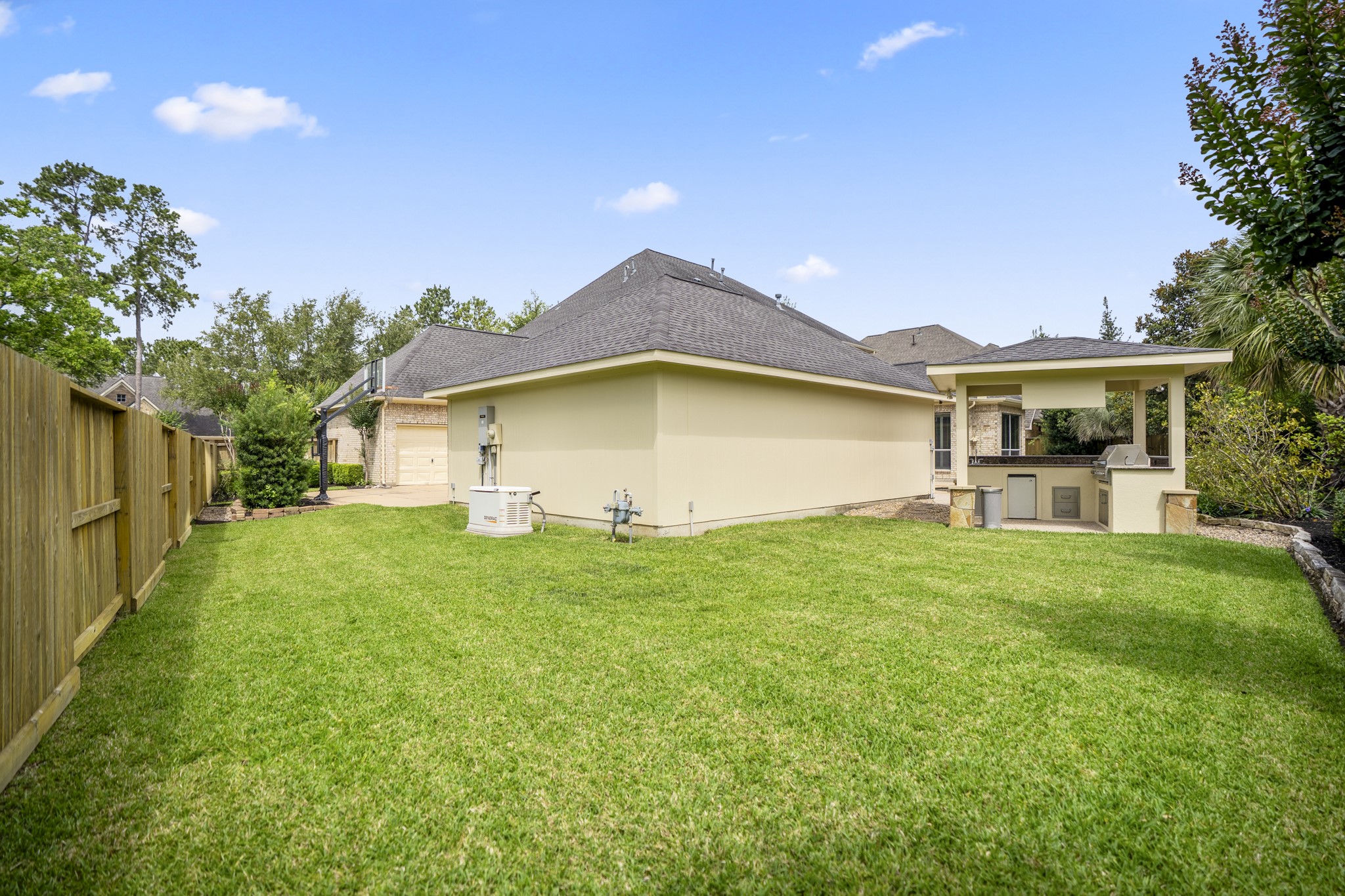 1438 Hatchmere Place Spring, TX 77379 - Photo 37 of 50 There is a large grassy area for children and pets to play as well as additional highlight, that includes a whole home Generac Generator with separate gas line PLUS rare 4-car garage with carport.