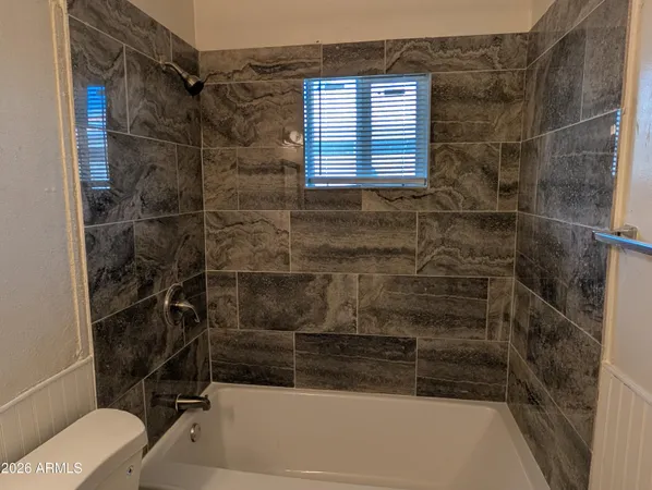 a bathroom with a shower and a toilet