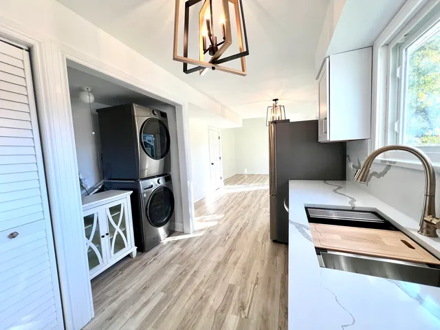 a kitchen with stainless steel appliances a stove a sink and a refrigerator