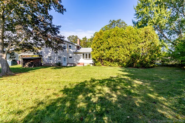 a view of yard with swimming pool and green space