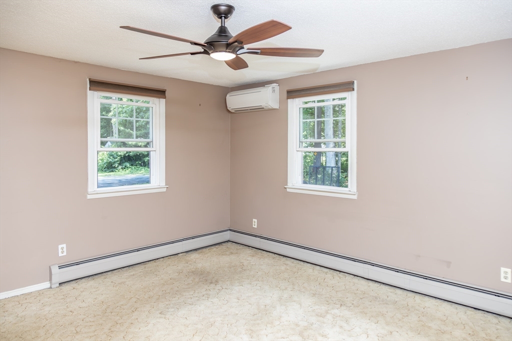 67 Hillside Road Montague, MA 01351 - Photo 14 of 26 an empty room with a window and a fan