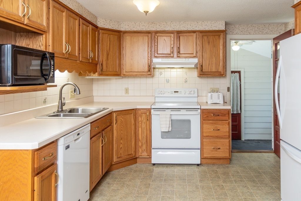 67 Hillside Road Montague, MA 01351 - Photo 7 of 26 a kitchen with stainless steel appliances granite countertop a sink stove and refrigerator