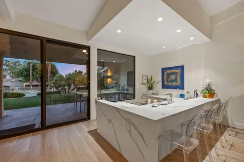 a large kitchen with stainless steel appliances lots of counter space and a sink