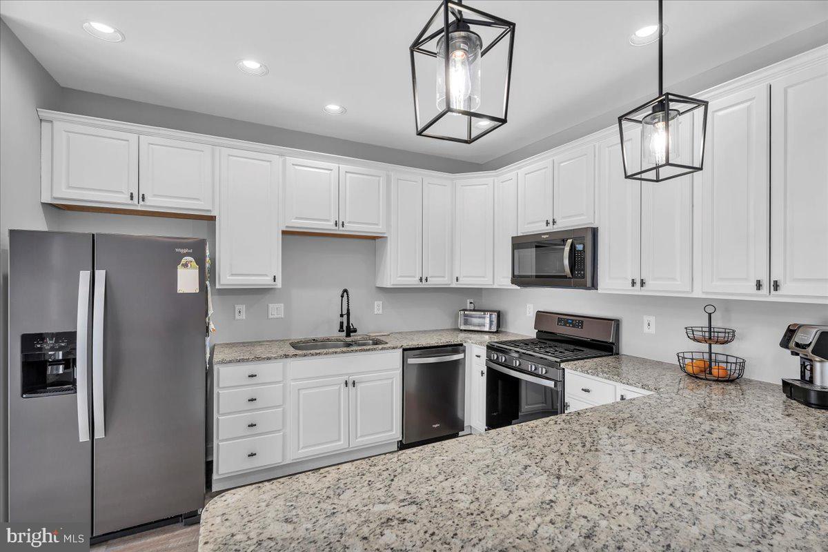 35 Beaumont Place Westampton, NJ 08060 - Photo 10 of 21 a kitchen with stainless steel appliances granite countertop a refrigerator a sink dishwasher a stove and white cabinets with wooden floor