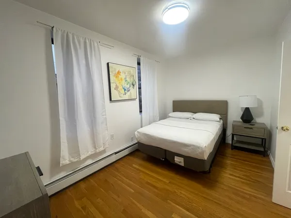 a bedroom with a bed and a window