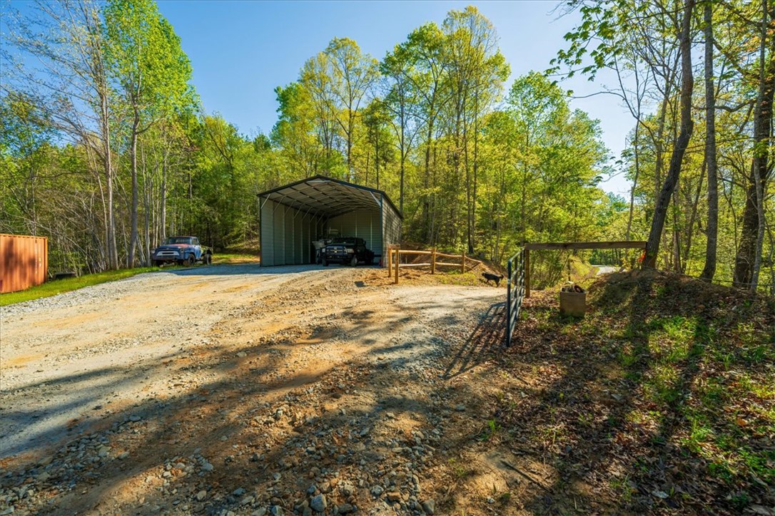 280 Dan Ross Road Six Mile, SC 29682 - Photo 24 of 24 This expansive property features a spacious garage, offering ample space for vehicles and storage amidst natural surroundings.