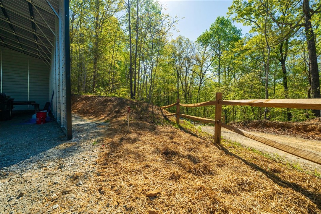 280 Dan Ross Road Six Mile, SC 29682 - Photo 6 of 24 This property features a sturdy outbuilding and a charming wooden fence, offering both utility and rustic appeal.