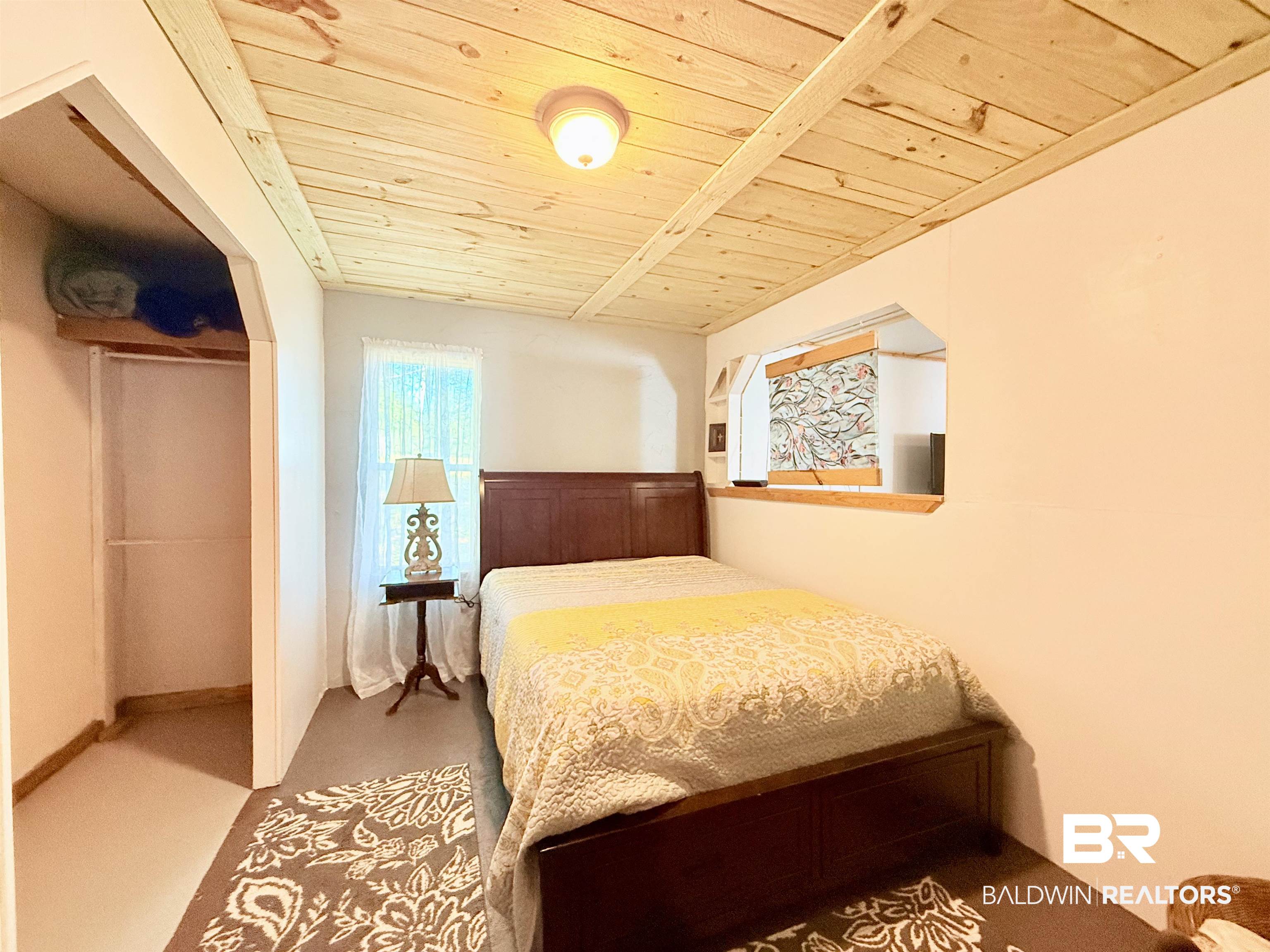 21305 River Road Robertsdale, AL 36567 - Photo 28 of 50 Bedroom featuring wood ceiling and a closet