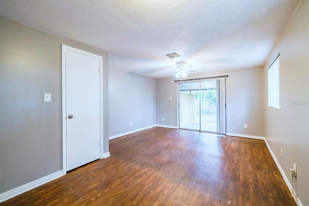 2507 West Virginia Avenue, Unit D Tampa, FL 33607 - Photo 8 of 12 a view of an empty room with wooden floor and a window
