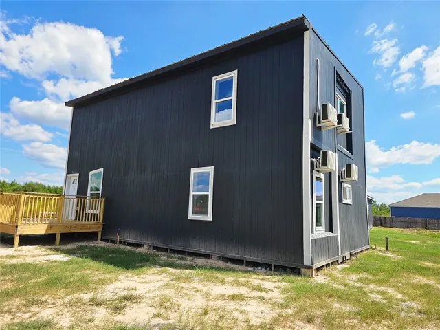 a view of an house with backyard space and balcony
