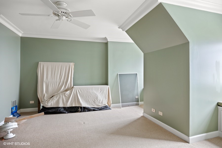 889 Sheridan Road Winnetka, IL 60093 - Photo 16 of 37 a view of an empty room with wooden floor and a ceiling fan