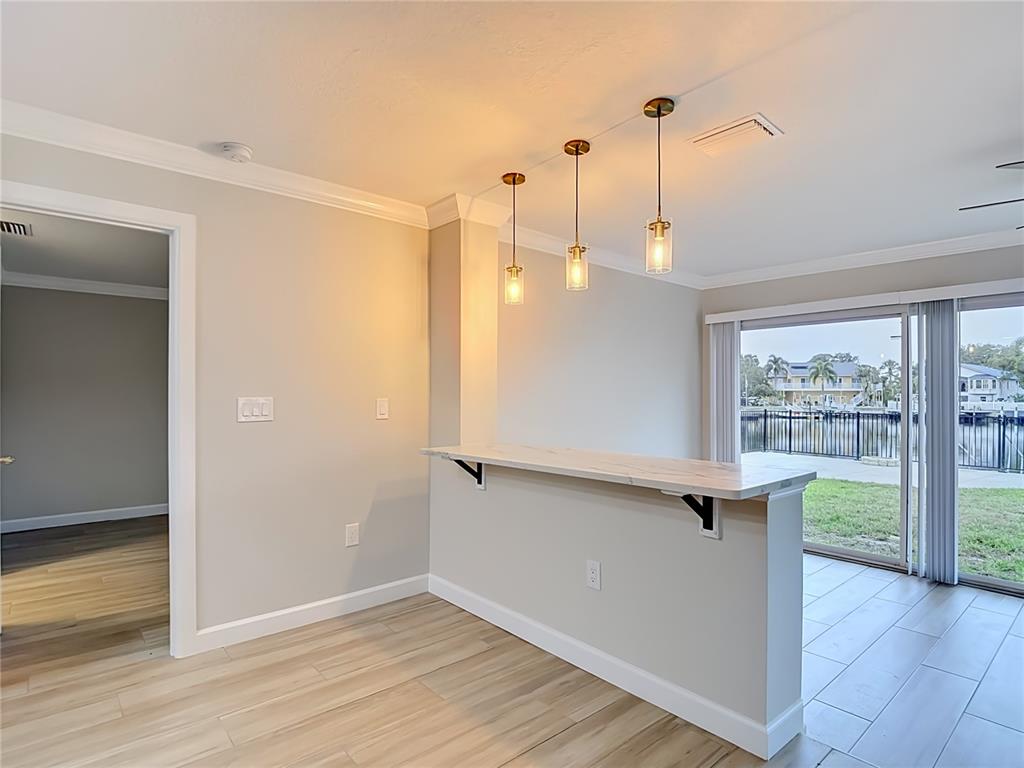 4536 Mitcher Road New Port Richey, FL 34652 - Photo 34 of 46 a view of an empty room with wooden floor and a window