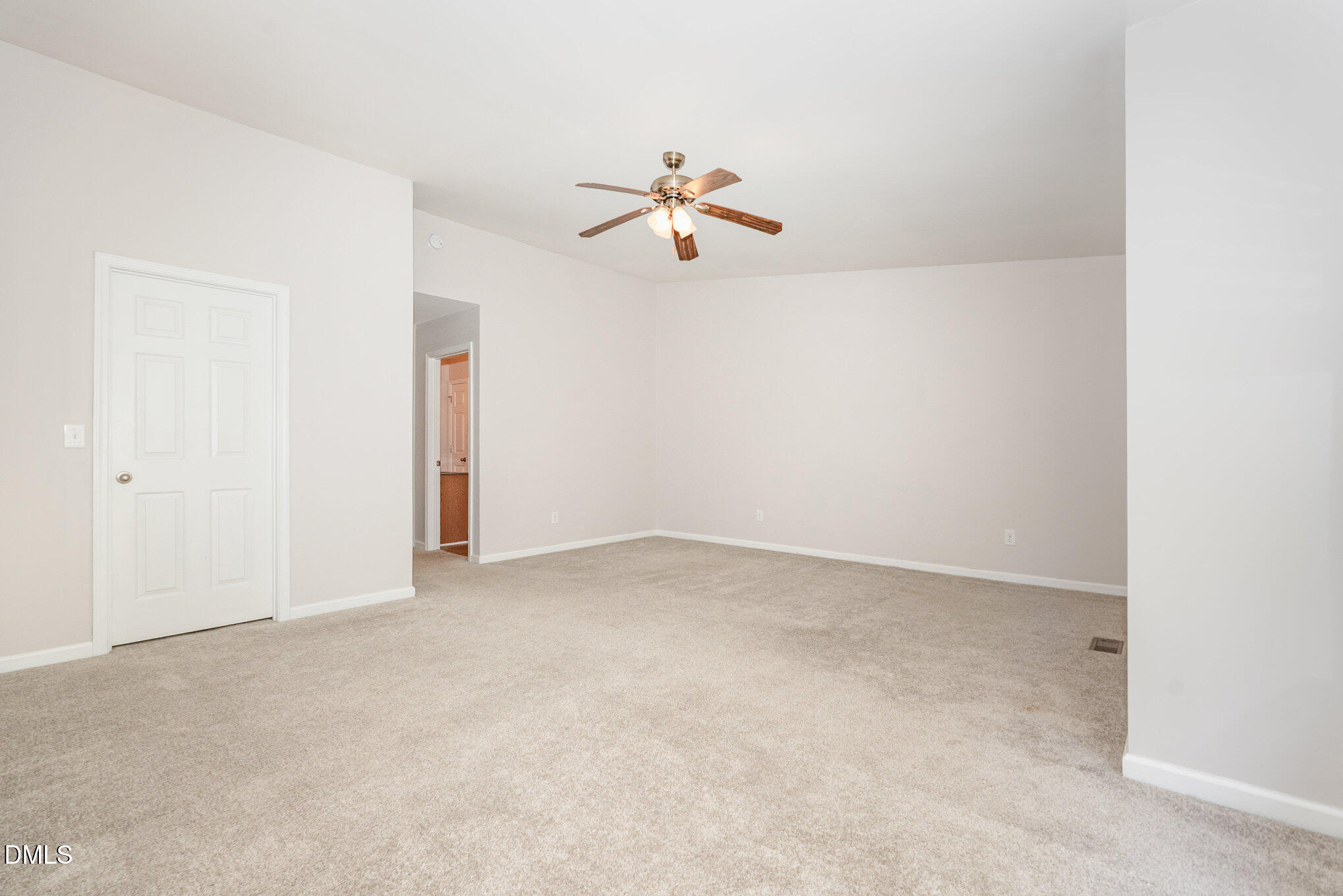311 Gilman Lane, Unit 107 Raleigh, NC 27610 - Photo 15 of 21 an empty room with chandelier fan and windows
