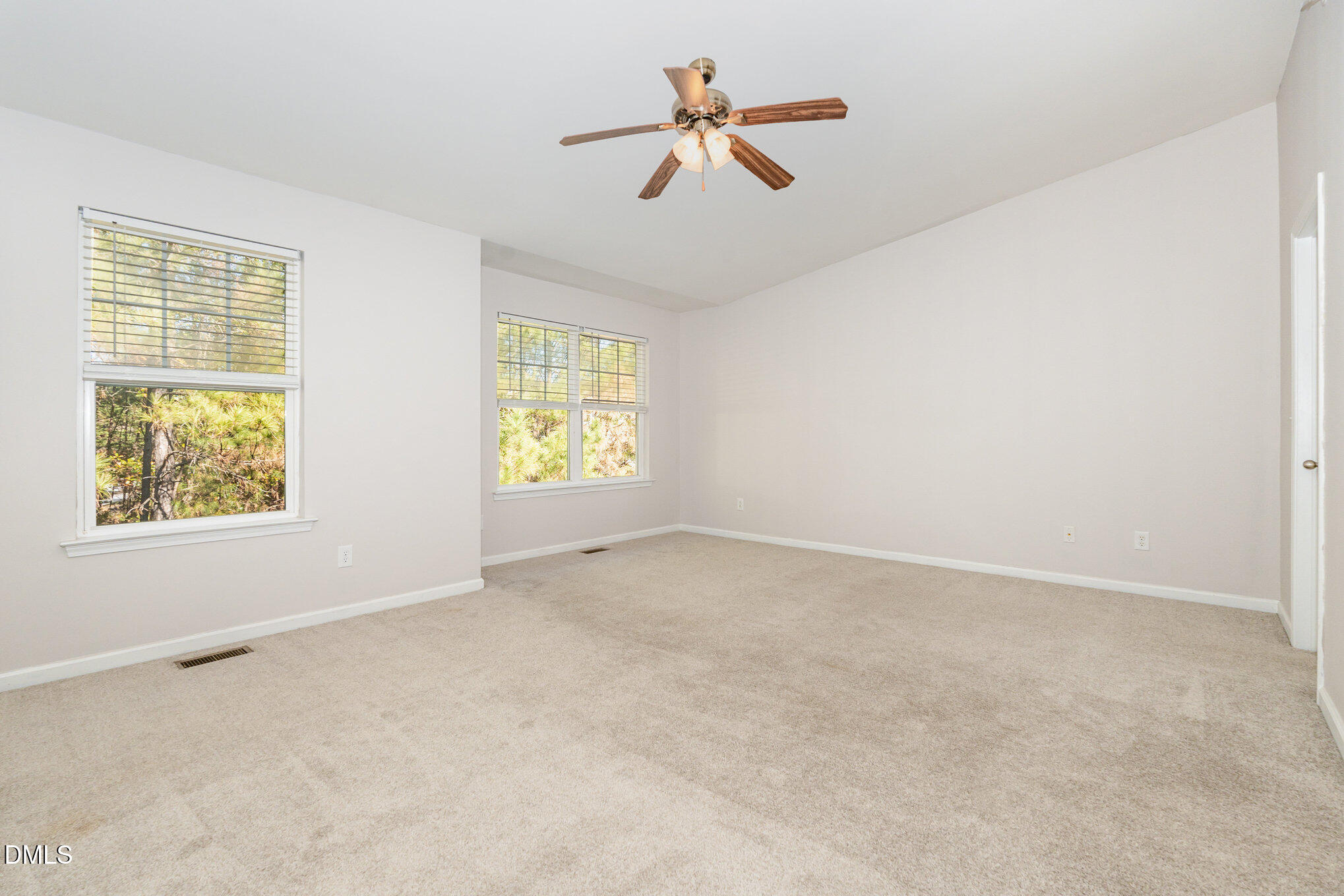 311 Gilman Lane, Unit 107 Raleigh, NC 27610 - Photo 16 of 21 an empty room with windows and fan