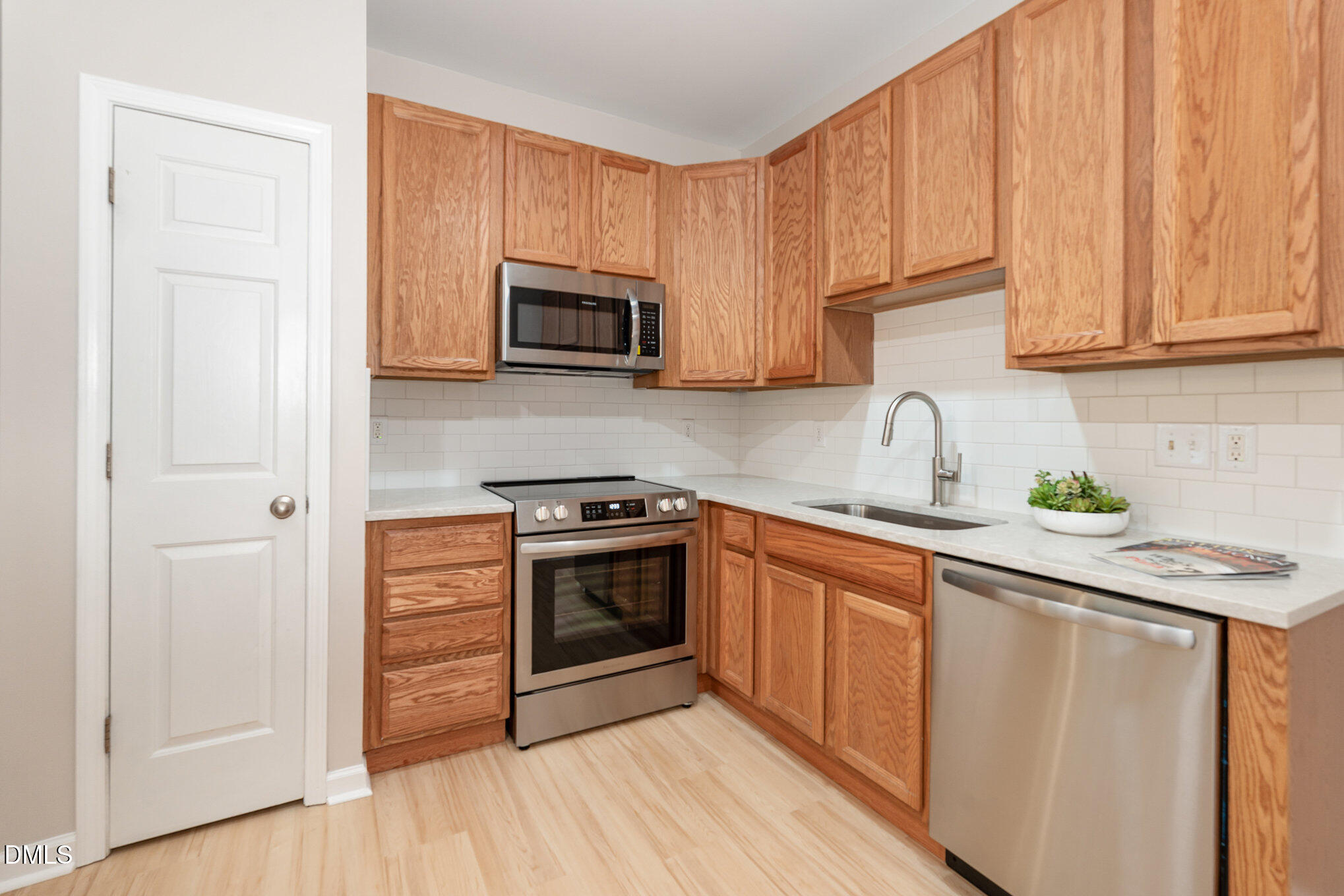 311 Gilman Lane, Unit 107 Raleigh, NC 27610 - Photo 7 of 21 a kitchen with stainless steel appliances granite countertop a sink stove and microwave