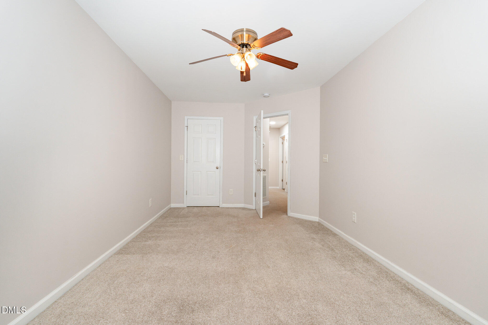 311 Gilman Lane, Unit 107 Raleigh, NC 27610 - Photo 9 of 21 an empty room with window and ceiling fan