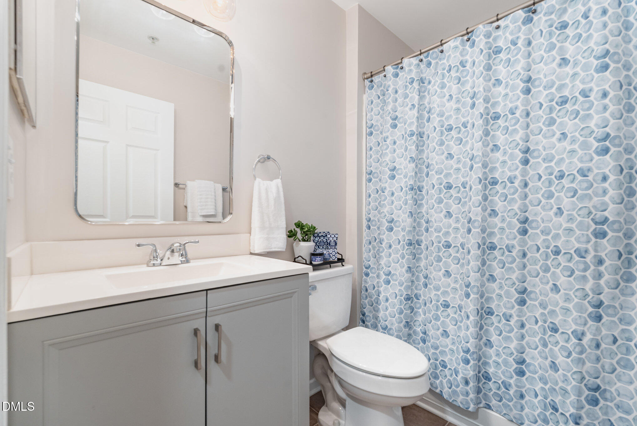 311 Gilman Lane, Unit 107 Raleigh, NC 27610 - Photo 10 of 21 a bathroom with a granite countertop toilet sink and mirror