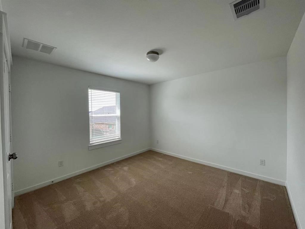 815 Summer Village Way Rosenberg, TX 77469 - Photo 19 of 21 an empty room with a window