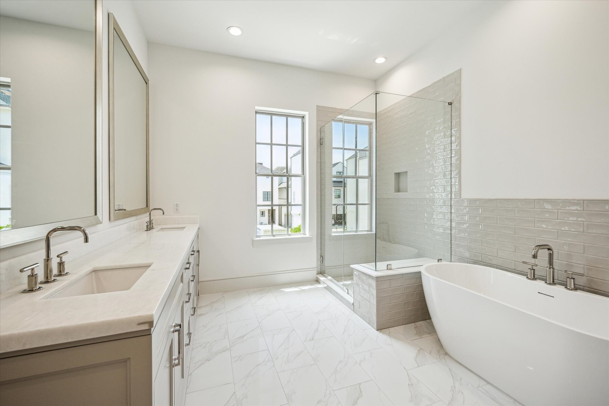 209 Sutton Row Place Houston, TX 77024 - Photo 10 of 23 Opal White Polished Marble countertops with double sinks, soaking tub and glass walk-in shower.