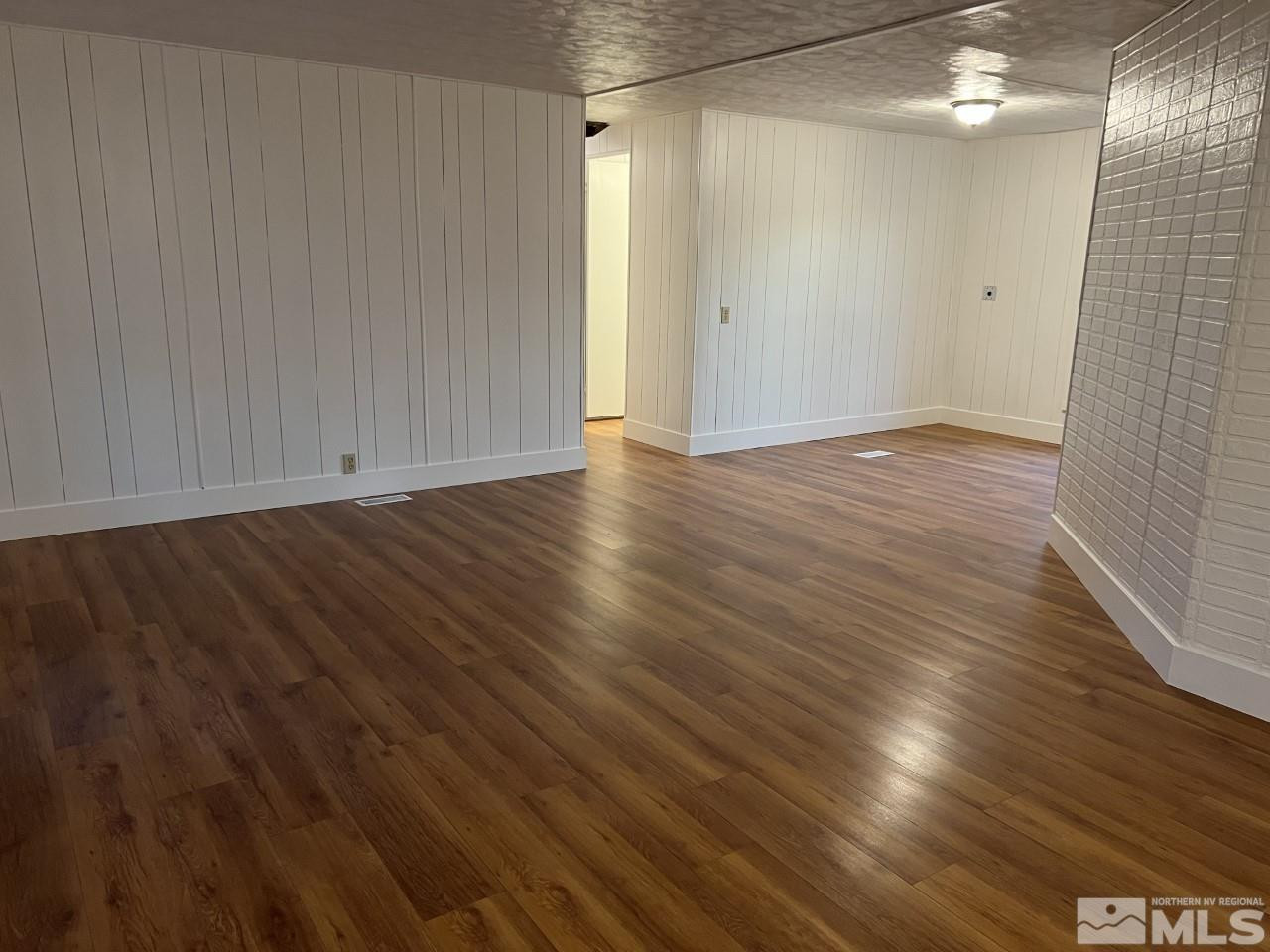 16160 Rhyolite Circle Reno, NV 89521 - Photo 2 of 14 a view of an empty room with wooden floor