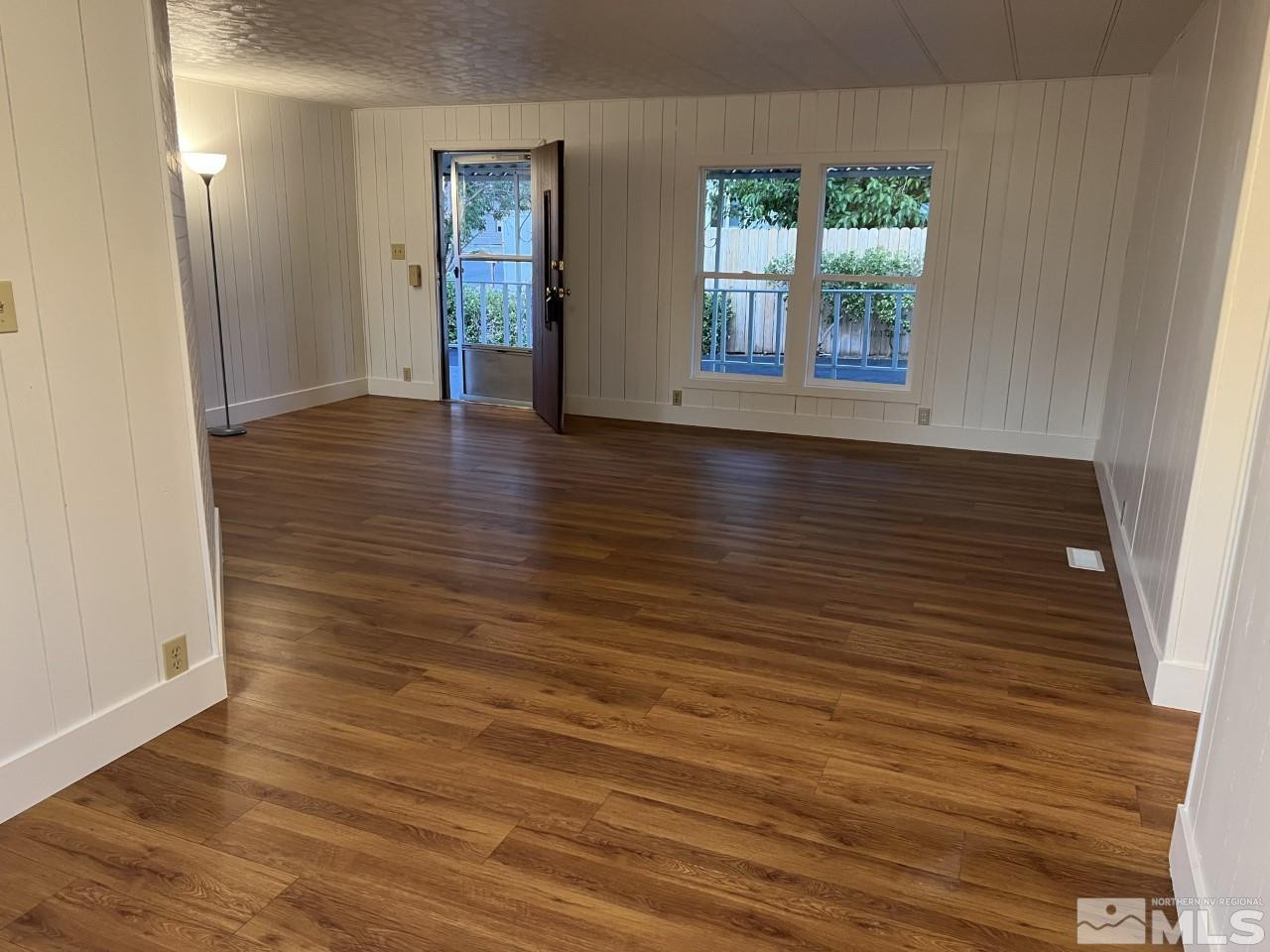 16160 Rhyolite Circle Reno, NV 89521 - Photo 3 of 14 an empty room with wooden floor and windows