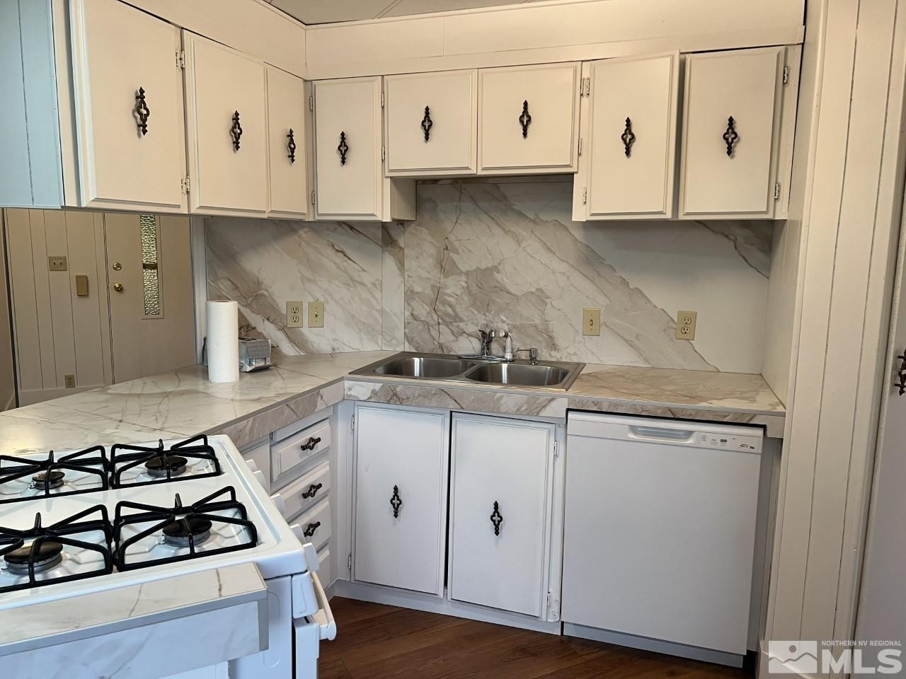 16160 Rhyolite Circle Reno, NV 89521 - Photo 5 of 14 a kitchen with white cabinets and white appliances
