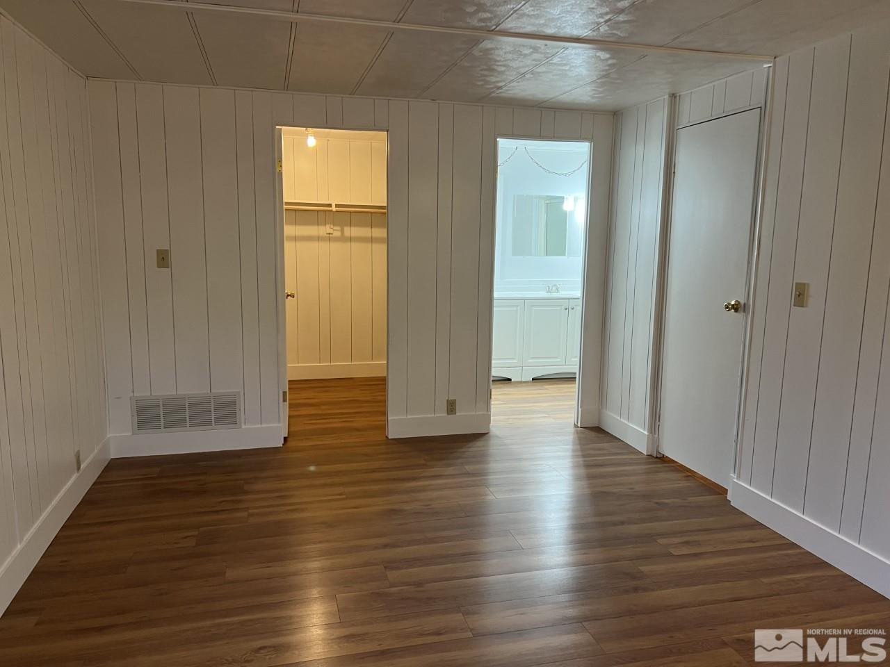 16160 Rhyolite Circle Reno, NV 89521 - Photo 8 of 14 a view of an empty room with wooden floor and a window