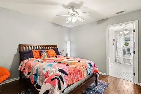 a bedroom with a bed and wooden floor