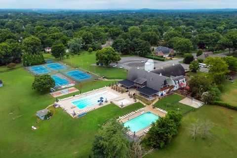 an aerial view of a house with yard