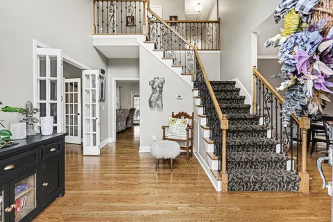 a view of an entryway and hall with wooden floor