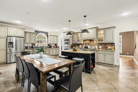 a kitchen with granite countertop a center island and stainless steel appliances