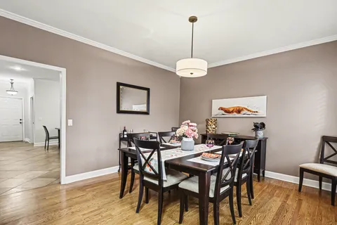 a view of a dining room with furniture wooden floor and chandelier