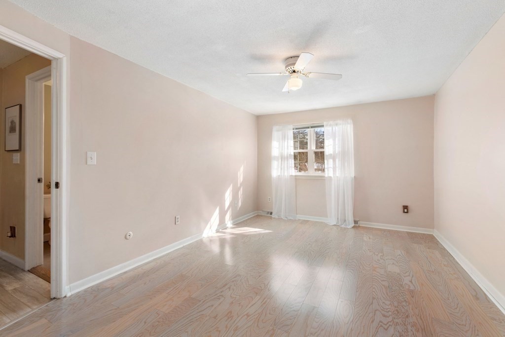 20 Hemlock Circle, Unit 20 Millis, MA 02054 - Photo 11 of 27 a view of an empty room with wooden floor and a window