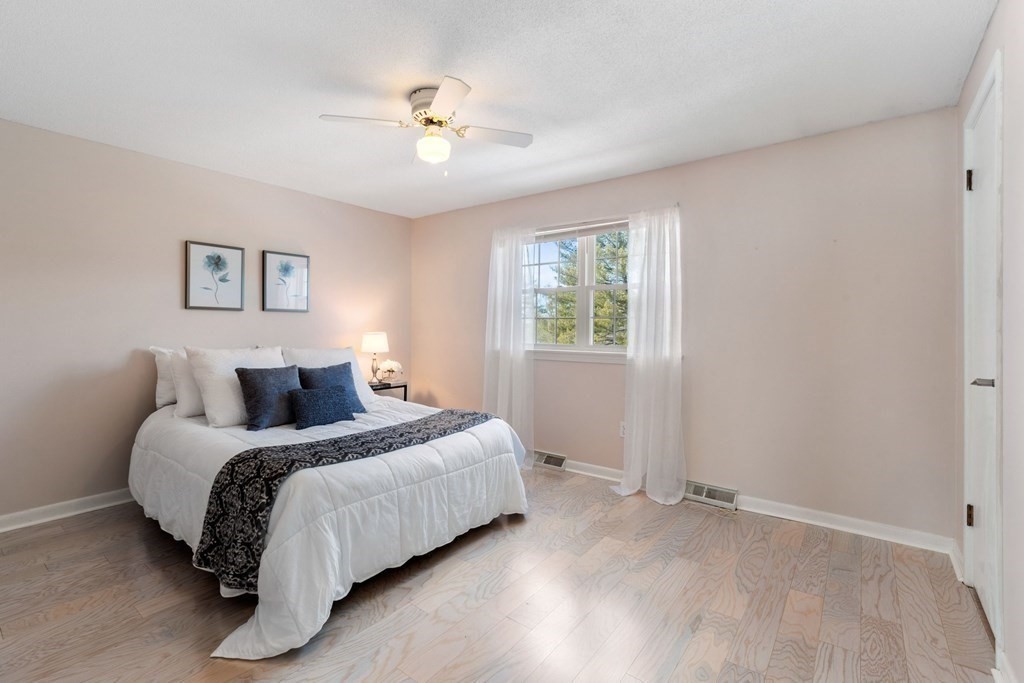 20 Hemlock Circle, Unit 20 Millis, MA 02054 - Photo 13 of 27 a bedroom with a bed and a chandelier