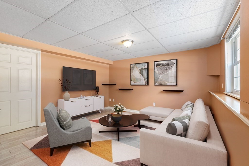 20 Hemlock Circle, Unit 20 Millis, MA 02054 - Photo 17 of 27 a living room with furniture and a flat screen tv