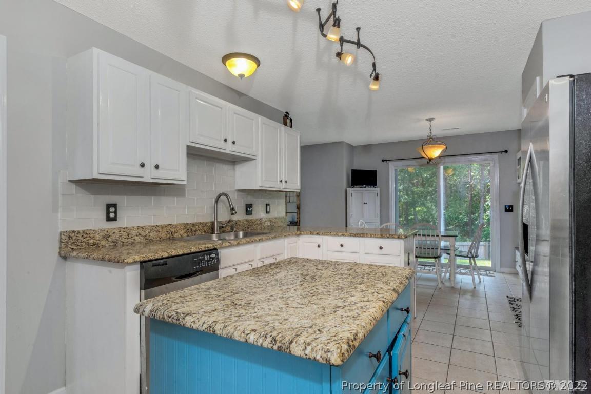 226 Linden Road Cameron, NC 28326 - Photo 15 of 36 a kitchen with kitchen island a counter top space a sink stainless steel appliances and cabinets