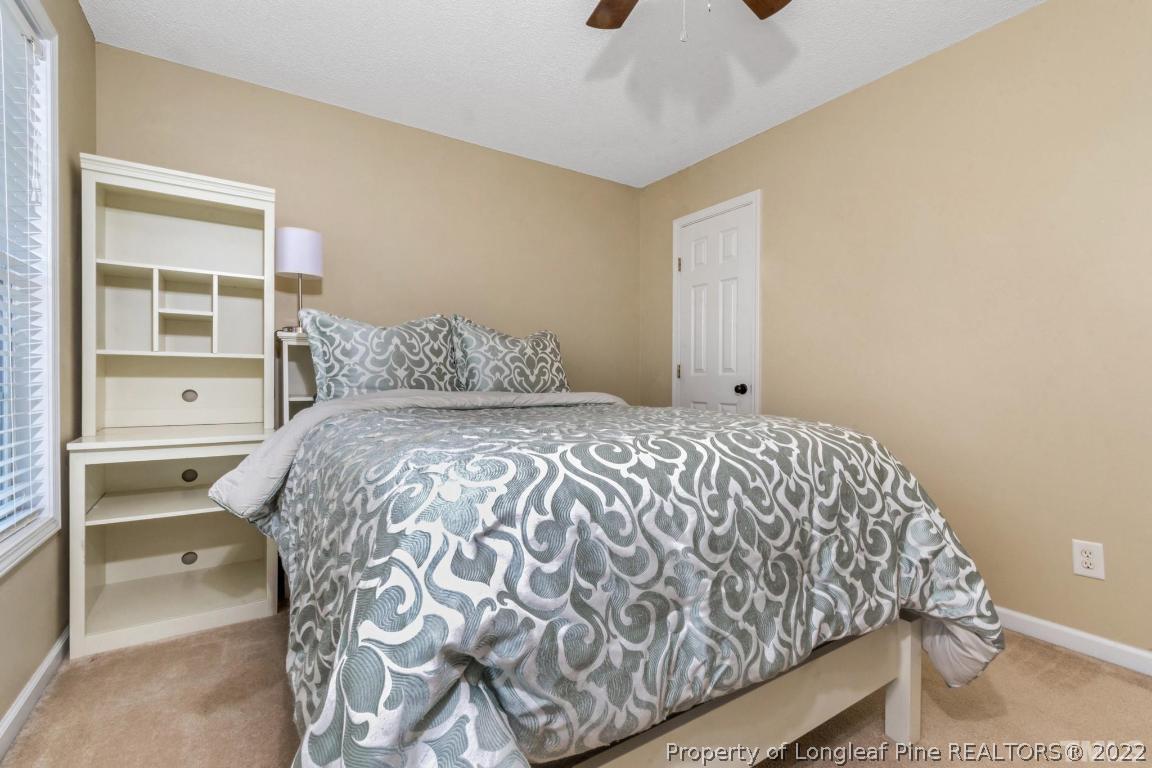 226 Linden Road Cameron, NC 28326 - Photo 23 of 36 a bed sitting in a bedroom next to a window