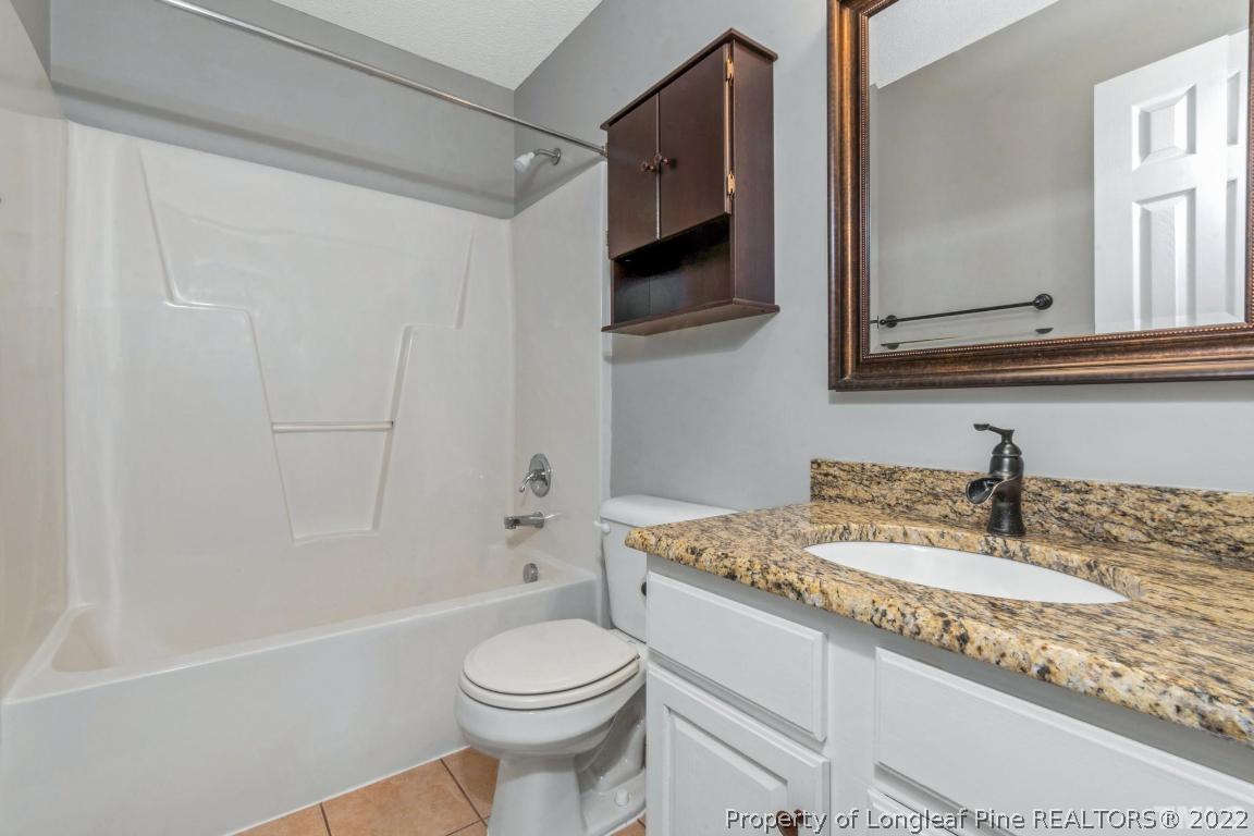 226 Linden Road Cameron, NC 28326 - Photo 27 of 36 a bathroom with a granite countertop sink mirror vanity and toilet
