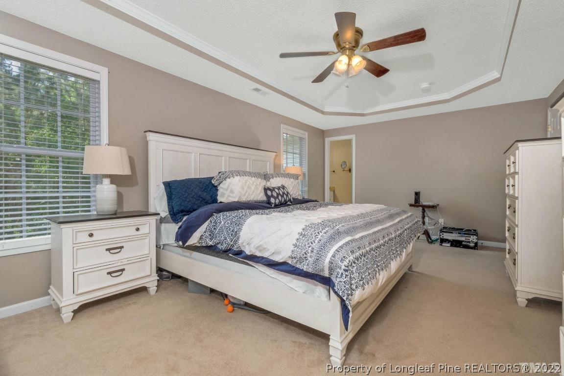 226 Linden Road Cameron, NC 28326 - Photo 29 of 36 a bedroom with a bed and a chandelier