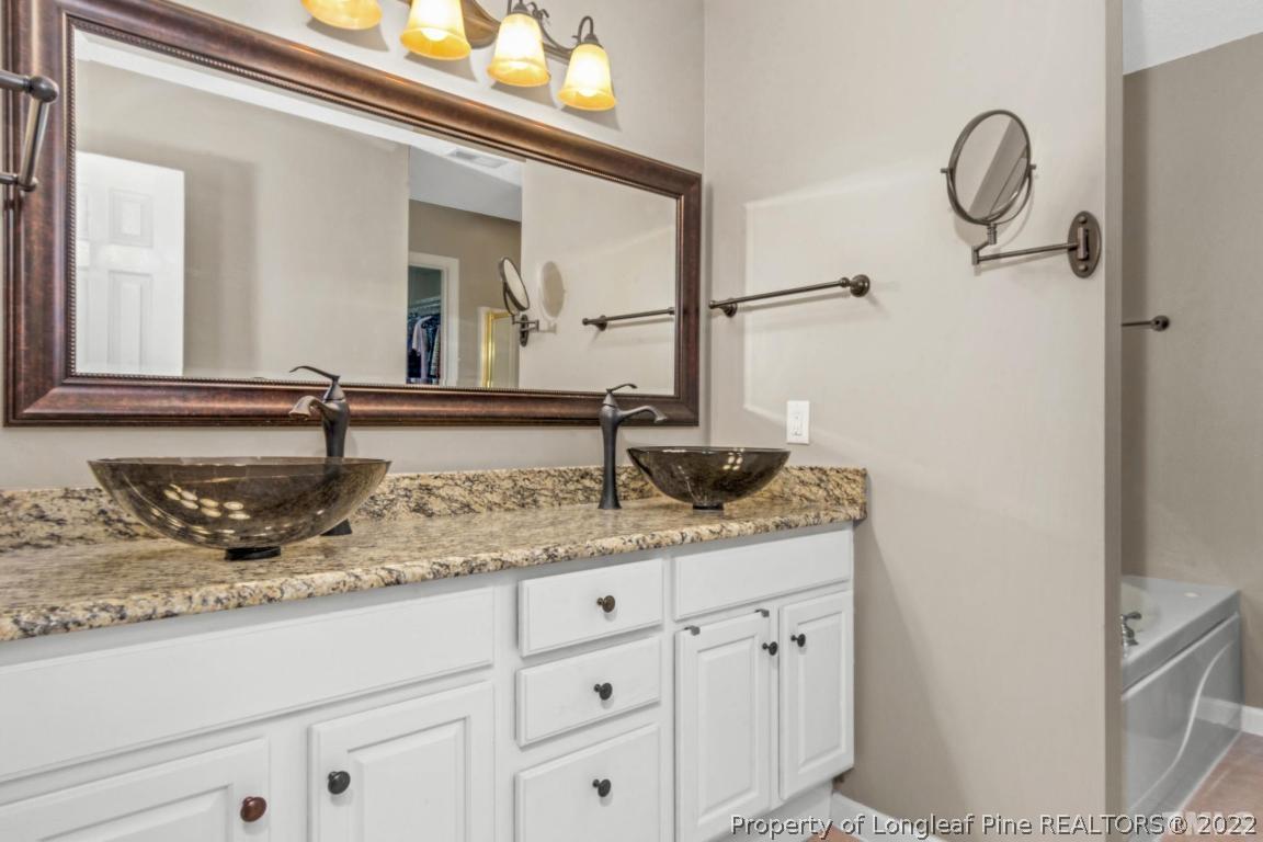 226 Linden Road Cameron, NC 28326 - Photo 30 of 36 a bathroom with a granite countertop sink and a mirror